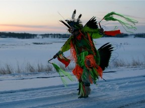 Tyler Yazzie dances outside in Onion Lake, Sask. during the COVID-19 pandemic.