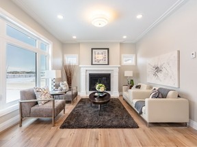 The show home at 302 Boykowich Street combines traditional elements with a modern west coast vibe. The living room features a very traditional layout with a fireplace. A herring-bone tiled fireplace surround with white mantel will serve as a gathering place for family and friends. (Sask Real Estate/David Oh)