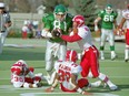 Ray Elgaard of the Saskatchewan Roughriders tramples Calgary Stampeders defenders on Oct. 23, 1993 at Taylor Field.