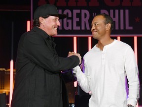 Phil Mickelson, left, and Tiger Woods greet each other at The Match: Tiger vs Phil VIP after party at Topgolf Las Vegas on Nov. 23, 2018 in Las Vegas, Nevada. (Ethan Miller/Getty Images for The Match)