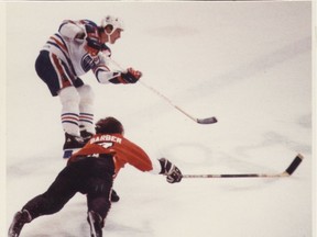 In this file photo from Dec. 30, 1981, Wayne Gretzky gets past Flyers Bill Barber to score his 50th goal.