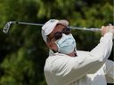Winston Casey of Arlington, VA, who does not have a spleen, an important immune system organ, wears a mask to protect against the coronavirus disease (COVID-19) on the driving range before his round of golf at Westfields Golf Club in Clifton, Virginia, U.S., April 21, 2020. REUTERS/Kevin Lamarque