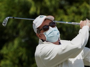 Winston Casey of Arlington, VA, who has no spleen, an important immune system organ, wears a mask to protect against the coronavirus disease (COVID-19) on the practice range before his round of golf at Westfields Golf Club in Clifton, Virginia, U.S., April 21, 2020. REUTERS/Kevin Lamarque