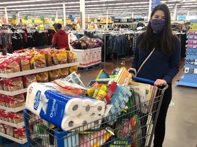 A volunteer from the Student Medical Society of Saskatchewan shops for supplies that will be set to La Loche to help residents during the COVID-19 pandemic. (Supplied)