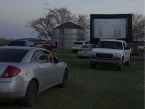 Ben Giglio watches a movie outside of a car during the Cinema Under the Stars drive-in theatre at  Agar's Corner just outside Saskatoon, Saturday, May, 16, 2020.
Saskatoon StarPhoenix / Kayle Neis
