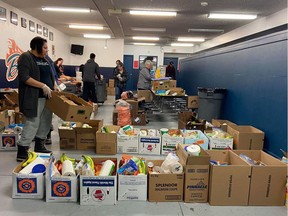 Volunteers at the Turnor Lake and Birch Narrows Community Food Centre prepare food packages to be delivered to the community. Every two weeks, about 200 packages are sent out.