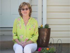 Janis Walsh, a volunteer with the Canadian Cancer Society's Peer Match Program, sits in front of her home in Regina, Saskatchewan on May 29, 2020. The Canadian Cancer Society announced it is indefinitely suspending its Peer Match Program because of the financial impact of COVID-19.