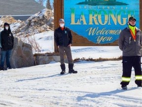 Men of the North members, from left to right, Riley Caron, Jordan McPhail, and Christopher Merasty stand in front of the sign welcoming visitors to La Ronge, SK. Picture taken by Daniel Despine and supplied by Christopher Merasty on May 25, 2020. (Saskatoon StarPhoenix).