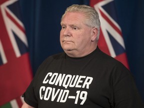 Ontario Premier Doug Ford updates the province on the fight to stop the COVID-19 pandemic while wearing a "Conquer COVID-19" T-shirt on Saturday, April 11, 2020.
