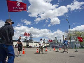Unifor members social distance on the picket line outside of the Co-op Refinery in Regina, Sask., on May 27, 2020. The labour dispute at the Regina refinery is nearing six months.
