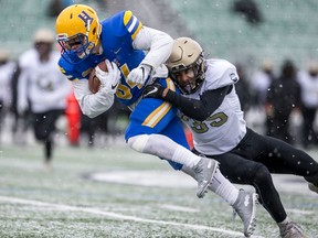 Saskatoon Hilltops receiver Dillan Heintz is tackled by Edmonton Huskies defensive back Mitchell Choma-Phillips during the Prairie Football Conference championship game at SMF field in Saskatoon on Sunday, October 27, 2019.