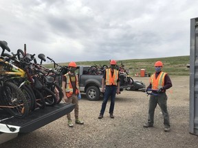 Left to right, BCBC volunteers Dana Durell, Bill Henley, and Scott McGibney at Saskatoon's landfill, gathering bikes that will eventually be repaired and rehomed to Saskatoon residents. Photo supplied by Bridge City Bicycle Co-op