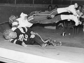 Roller-derby standout Diane Syverson (top) dives over famed opponent Bud Atkinson during a 1974 event at the Saskatoon Arena.