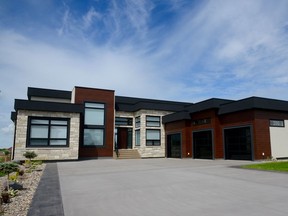 The exterior of 200 Greenbryre Lane is maintenance free with stucco, stone, and metal accents. The contrasting white stucco with the black and rich wood accents create modern curb appeal. (Jennifer Jacoby-Smith/The StarPhoenix)