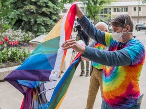 Natasha King, co-chair of the Saskatoon Pride board, prepares to raise a pride flag at City Hall.