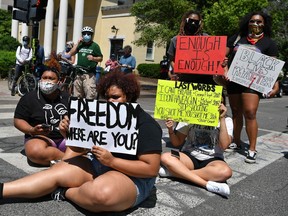 People protest the death of George Floyd, an unarmed black man who died while while being arrested and pinned to the ground by the knee of a Minneapolis police officer, outside Lafayette Square near the White House in Washington, DC on June 1, 2020.