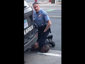 This still image taken from a May 25, 2020, video courtesy of Darnella Frazier via Facebook, shows a Minneapolis, Minn., police officer arresting George Floyd.