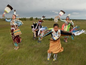 (From left) Dabney Warren, TJ Warren and their daughters, Kiihibaa Warren and Omiyosiw Warren, dance by the empty powwow arena at Wanuskewin Heritage Park. This is the family's first summer without travelling to and competing on the powwow circuit. "My daughters are champion dancers on the bigger powwow circuit. Both have won many championships all across North America," TJ says.
