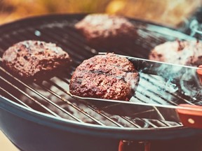 Closeup photo of a tasty vegetarian burger on the grill outdoors, bbq picnic, healthy delicious food, happy summer weekend