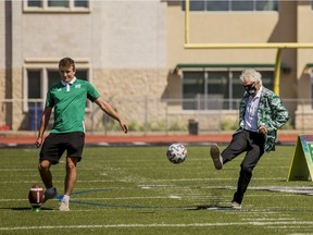 University of Saskatchewan president Peter Stoicheff, right, joined dignitaries, U of S staff and student athletes in a kick-off at the announcement of major funding provided by the Government of Saskatchewan, involving the turf replacement project at Griffiths Stadium.