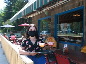 Victoria Charney serves drinks on the patio at Las Palapas.