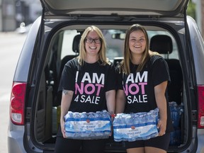 Hayley James, left, and Julee Gingera are part of the EGADZ street outreach team. They have been handing out water and Gatorade, along with snacks and hygiene products, to help people stay cool during the heat of summer.