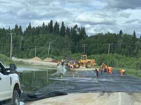 Work crews roll out equipment to fight flooding in North Saskatchewan this week as overflow hinders road access. Photo supplied by Bernice Jay Desiardin on July 2, 2020. (Saskatoon StarPhoenix.)