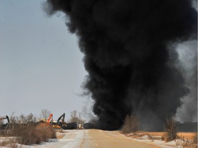 Smoke billows from the wreckage of a Canadian Pacific Railway Ltd. train hauling crude oil, which derailed near Guernsey, Sask. on Dec. 9, 2019.