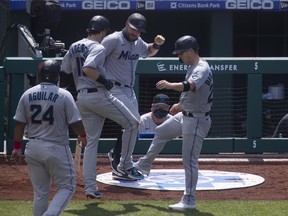 Jesus Aguilar #24, Brian Anderson #15, Francisco Cervelli #29, and Corey Dickerson #23 of the Miami Marlins react after a three run home run by Anderson in the top of the fifth inning against the Philadelphia Phillies at Citizens Bank Park on July 26, 2020 in Philadelphia, Pennsylvania.