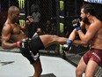 Kamaru Usman of Nigeria kicks Jorge Masvidal in their UFC welterweight championship fight during the UFC 251 event at Flash Forum on UFC Fight Island on July 12, 2020 on Yas Island, Abu Dhabi, United Arab Emirates.