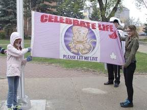 In this file photo from 2016, members of the Prince Albert Right to Life Association display the Celebrate Life Week flag that caused controversy over the city's community flagpole policy. (Prince Albert Daily Herald file photo)