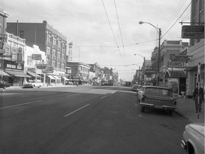 A photo of people walking along a downtown street, from Aug. 13, 1963. (City of Saskatoon Archives StarPhoenix Collection S-SP-B3018-1)