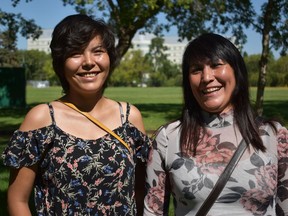 Marcia Bird, left, and Debbie Thomas of Kohkums and Mushoms Against Drugs and Alcohol (KAMADA), right, speak in Saskatoon's Kinsmen Park about their new effort to post pictures of missing persons on First Nations bill boards. (Saskatoon StarPhoenix/Nick Pearce)