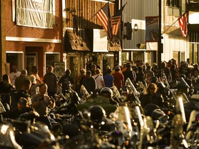 People walk along Main Street in Sturgis, S.D., on Saturday during the 80th annual Sturgis Motorcycle Rally.