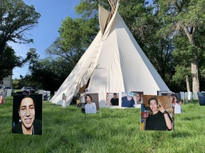 Faces of suicide victims surround a teepee on the lawns near the Legislative Building in Regina. The teepee was established by a group bringing awareness to the high rates of suicide in the province, especially amongst Indigenous people.