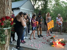 Family and friends of Dartagnan Whitehead gather for a vigil on Tuesday, Aug. 11, 2020 in the driveway of the rental house where he was killed on July 11, 2020.