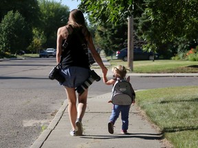 Saskatoon StarPhoenix photojournalist Michelle Berg takes a walk with her 22-month-old daughter Olivia before heading off to a photoshoot in Saskatoon on Friday, Aug. 14, 2020.