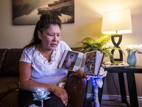 Lillian Thomas looks at pictures of her son, Preston Logan Thomas, who was found dead on Aug 1 at the Saskatoon Inn.