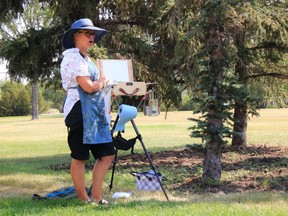 DeLee Grant demonstrates en plein air painting to participants in her workshop Expressive Brushwork en Plein Air outside the Art Gallery of Regina on August 22, 2020.