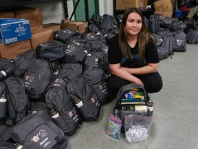 White Buffalo Youth Lodge's Stephanie Ahenakew displays the contents of one of the 1,500 backpacks the Saskatoon Tribal Council is distributing to children in the community, including masks and hand sanitizer.
