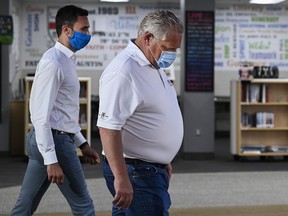 Ontario Premier Doug Ford and Education Minister Stephen Lecce, left, prepare for an announcement at Father Leo J. Austin Catholic Secondary School in Whitby, Ont., Thursday, July 30, 2020.