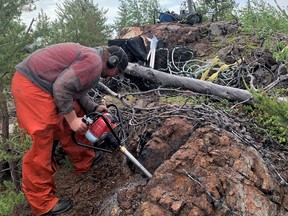 A geologist drills into a rusty outcrop on a historical gold showing near Stony Rapids in July 2020. Photo supplied by ALX resources