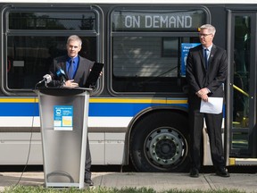 Nathan Luhning, Manager of Transit Administration for the City of Regina, left, explains a new "on demand" transit service during a news conference held on 3rd Avenue in Regina, Saskatchewan on August 26, 2020. Brad Bells, Director of Transit and Fleet stands to the side.