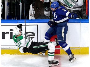 Luke Schenn #2 of the Tampa Bay Lightning checks Esa Lindell #23 of the Dallas Stars during the first period in Game One of the 2020 NHL Stanley Cup Final at Rogers Place on September 19, 2020 in Edmonton, Alberta, Canada.
