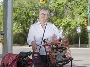 Cathy Watts with her bicycle at the intersection of Fourth Avenue and 23rd Street in Saskatoon on June 5, 2019.