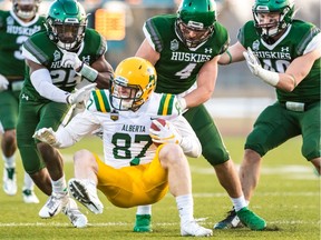 Three Huskies move in for the tackle during a game with Alberta this past season.