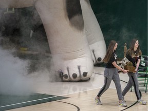 University of Saskatchewan Huskies women's basketball guards Megan Ahlstrom, left, and Sabine Dukate carry out the Bronze Baby trophy at a rally at the PAC at the PAC on the U of S campus in Saskatoon, on Wednesday, March 11, 2020, celebrating the teams second Canadian title.