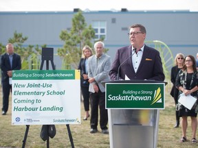 Saskatchewan Premier Scott Moe, at podium, speaks to media about the development of a new school in Regina's Harbour Landing area during a news conference on Albulet Drive in Regina, Saskatchewan on Sept. 16, 2020.