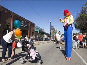 Kenni the Clown works the crowd at the Broadway Street Fair, Sept. 12, 2015.