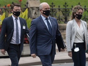Conservative Leader Erin O'Toole walks to a caucus meeting in Ottawa with his chief of staff Tausha Michaud and campaign manager Fred DeLorey in Ottawa on Sept. 9, 2020.